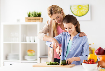 Image showing happy family cooking dinner at home kitchen