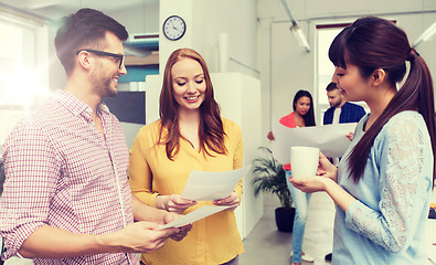 Image showing creative team on coffee break talking at office