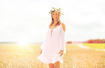 Image showing happy young woman in flower wreath on cereal field