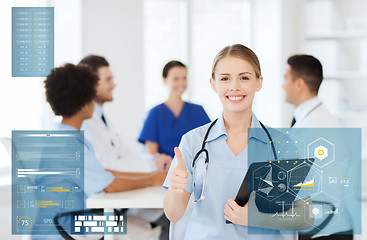 Image showing happy doctor at hospital showing thumbs up gesture