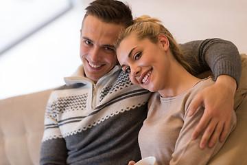 Image showing Young couple  in front of fireplace