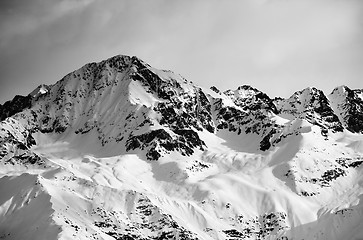 Image showing Black and white view on snow sunlight mountain and gray sky in e