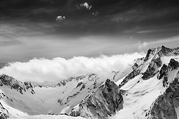 Image showing Black and white view on snow sunlight mountains in clouds