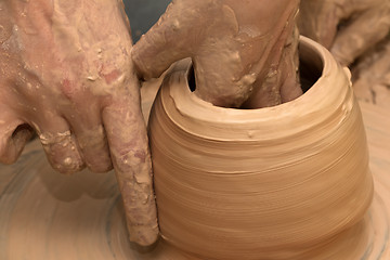 Image showing Process of making clayware on potter\'s wheel