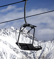 Image showing Chair lift in snowy mountains at nice sun day