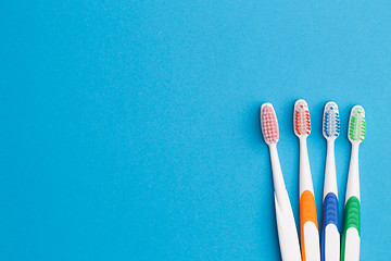 Image showing Colorful toothbrushes on blue background