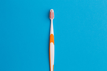 Image showing Photo of one orange toothbrush