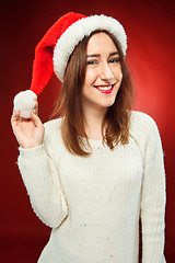 Image showing Surprised christmas girl wearing a santa hat