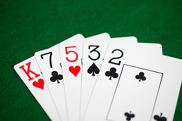 Image showing poker hand of playing cards on green casino cloth