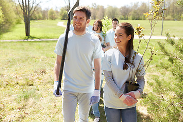 Image showing group of volunteers with trees and rake in park