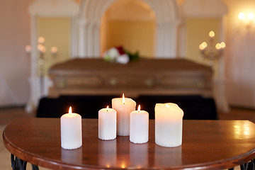 Image showing burning candles and coffin in church at funeral