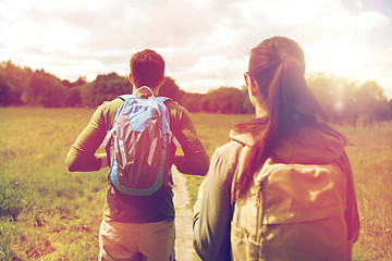 Image showing close up of couple with backpacks hiking outdoors