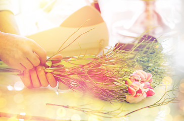 Image showing close up of man making bunch at flower shop