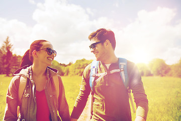 Image showing happy couple with backpacks hiking outdoors