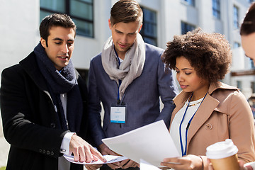 Image showing international business team with papers in city