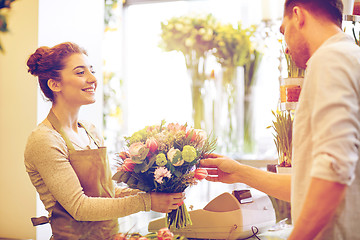 Image showing smiling florist woman and man at flower shop
