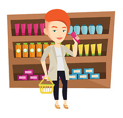 Image showing Customer with shopping basket and tube of cream.