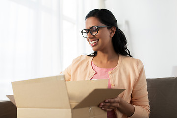 Image showing happy young indian woman with parcel box at home