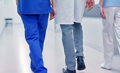 Image showing group of medics or doctors walking along hospital