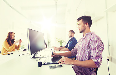 Image showing man or designer with computer and tablet at office