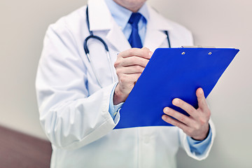 Image showing close up of doctor with clipboard at hospital