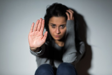 Image showing unhappy crying woman showing defensive gesture