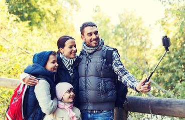 Image showing family with backpacks taking selfie and hiking