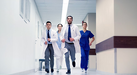 Image showing group of medics walking along hospital