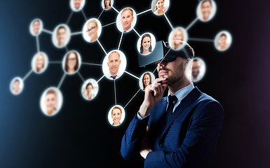 Image showing businessman in virtual reality headset over black