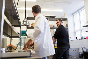 Image showing chef and cook cooking food at restaurant kitchen