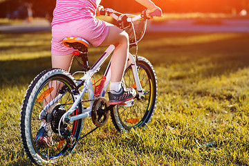 Image showing Little girl on a bicycle in summer park