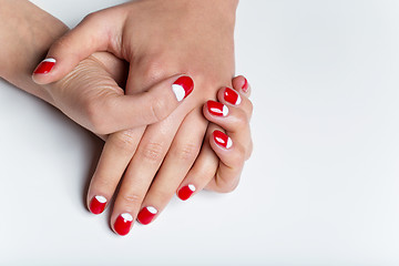 Image showing Female hands with red and white nails