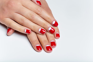 Image showing Female hands with red and white nails