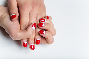 Image showing Female hands with red and white nails