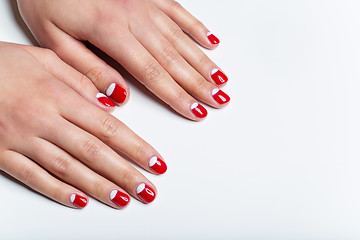 Image showing Female hands with red and white nails