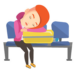 Image showing Exhausted woman sleeping on suitcase at airport.