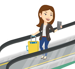 Image showing Woman using smartphone on escalator in airport.