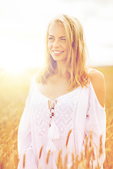 Image showing smiling young woman in white dress on cereal field