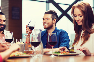 Image showing friends dining and drinking wine at restaurant