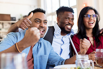 Image showing happy fans or friends at bar or restaurant