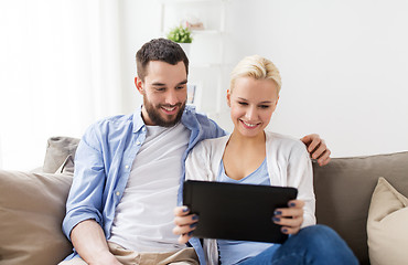 Image showing smiling happy couple with tablet pc at home