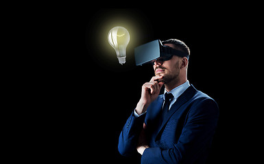 Image showing businessman in virtual reality headset over black