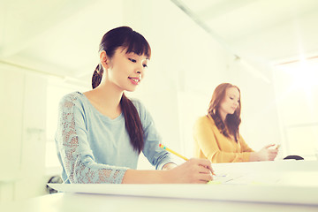 Image showing architect woman with blueprint writing at office