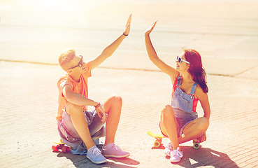 Image showing teenage couple with skateboards on city street