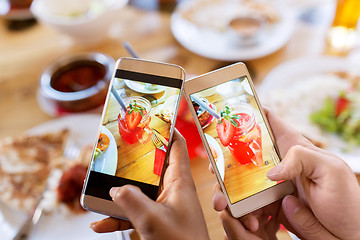 Image showing hands with drinks on smartphones at restaurant