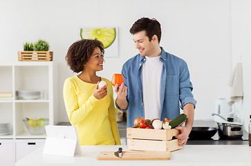 Image showing happy couple with healthy food at home kitchen