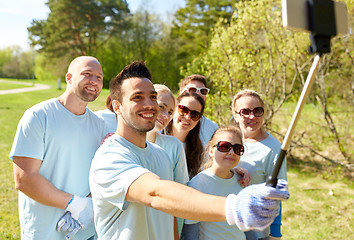 Image showing group of volunteers taking smartphone selfie