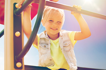 Image showing happy little girl climbing on children playground