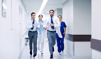 Image showing group of medics walking along hospital