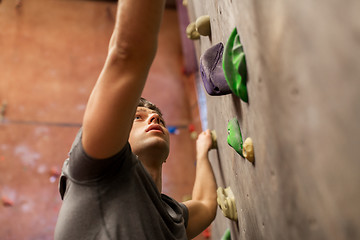 Image showing young man exercising at indoor climbing gym